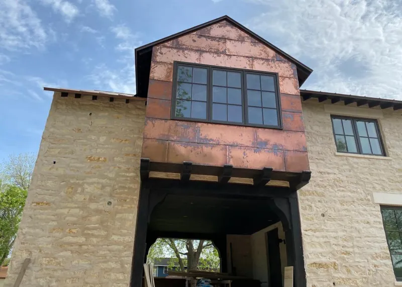 Copper metal panel facade on a stone building for Skylight Installation in Bonita Springs